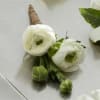 White Ranunculus Boutonniere gives a modern twist to the look of the