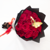 Bouquet of red roses wrapped in black paper with a butterfly decoration