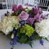 Mixed bouquet with hydrangeas, roses, and purple flowers on a table