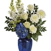 Blue vase with white and blue flowers and greenery
