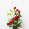Red roses and white lilies in a black container