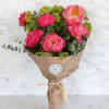 A lush hand-tied bouquet featuring premium coral charm peonies, known for their