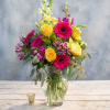 Bouquet of yellow roses and pink gerbera daisies in a glass vase
