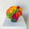 A vibrant mix of bright roses and seasonal blooms designed to bring