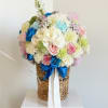 Soft white florals with vibrant blue accents arranged in a charming basket