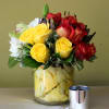 Roses yellow and orange, green orchids and white hydrangeas in a clear