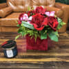 Red roses and orchids in a velvet hat box