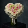 A handcrafted heart-shaped rose arrangement designed to celebrate love in a timeless