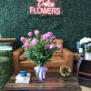 Beautiful Ecuadorian long stem roses arranged tall in a glass vase with