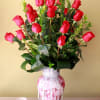 24 long stem roses in a tall ginger vase dress with crystals