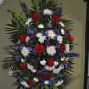 sympathy standing spray red white ad blue. red roses larkspur, spired mums