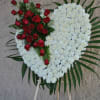 full carnation heart on a standing easel made of white carnations and