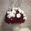 Romantic and extravagant red roses and white orchids arranged in a unique