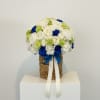 Classic white blooms paired with royal blue roses in a woven keepsake