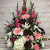 Beautifully arranged hydrangeas, pink Gerber daisies, red roses, red Gladiolas, white lilies