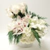 This elegant arrangement features white hydrangea, roses, calla lilies, cymbidiums, and cedar.