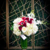 A mix of seasonal flowers including roses and hydrangeas arranged in a