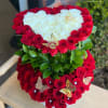 Heart-shaped arrangement of red and white roses with butterfly accents