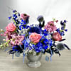 Blue and pink floral arrangement in a gray vase