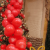 Vibrant red balloon gift adorned with a cheerful yellow bow, ideal for