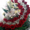 Red roses and white lilies arranged with baby's breath