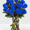 Blue roses arranged in a clear glass vase
