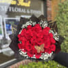 Bouquet of red roses with baby's breath in black wrap