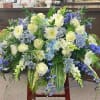 Large blue, white, and cream floral arrangement with cascading blooms