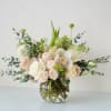 Blush and white floral arrangement in a clear glass vase
