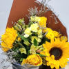 Bouquet of sunflowers, yellow roses, and pale yellow flowers in brown wrap