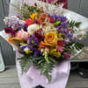 Fresh custom bouquet, tied and wrapped with a bow.  Designers Choice