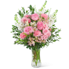 Pink roses and white flowers arranged in a clear glass vase