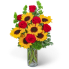 Bouquet of red roses and yellow sunflowers in a clear glass vase