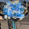 Bouquet of blue roses with white baby's breath and black wrapping