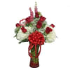Red roses and white flowers in a glass vase with a red bow