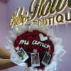 Heart-shaped bouquet of red roses with white wrapping and photo clips