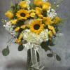 Bright yellow roses and sunflowers with white hydrangeas and greens in a