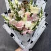 White and pink roses, lisianthus , alstroemeria and snapdragons and greenery in
