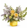 Teleflora's Sunshine Dreams Bouquet features yellow roses, yellow miniature carnations, lavender stock
