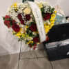 A large, wreath-style standing spray that quietly honors a life with classic
