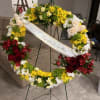 A large circular sympathy wreath designed to honor a life with both