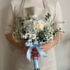 Creamy white roses paired with pale blue hydrangeas create a soft, romantic