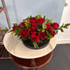 A dense cluster of rich red roses arranged low and full creates