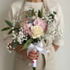 Cream roses paired with soft pink hydrangeas and airy sprays of baby's