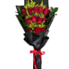 Bouquet of red roses wrapped in black paper with a red ribbon