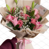 A delicate blend of pink roses and lilies, complemented with fresh greenery