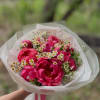 Vivid pink peonies take center stage in this springtime bouquet-perfect for a