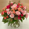 Bouquet of pink and coral roses in a clear glass vase
