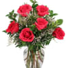 Bouquet of red roses in a clear glass vase