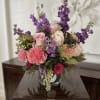 Elevate your space with our Radiant Garden Luxe arrangement. This premium floral